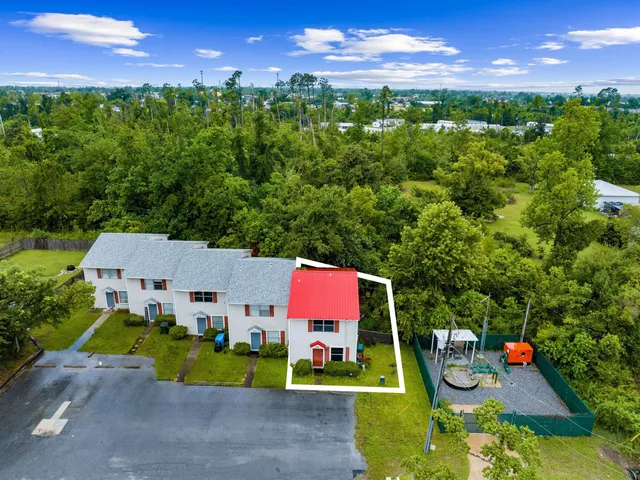 an aerial view of a house with yard swimming pool and outdoor seating