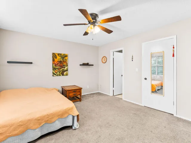 a spacious bedroom with a bed and a large window