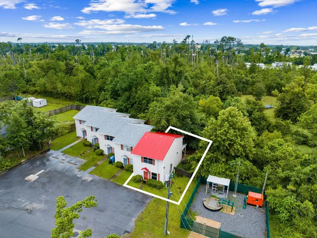 an aerial view of a house with a yard