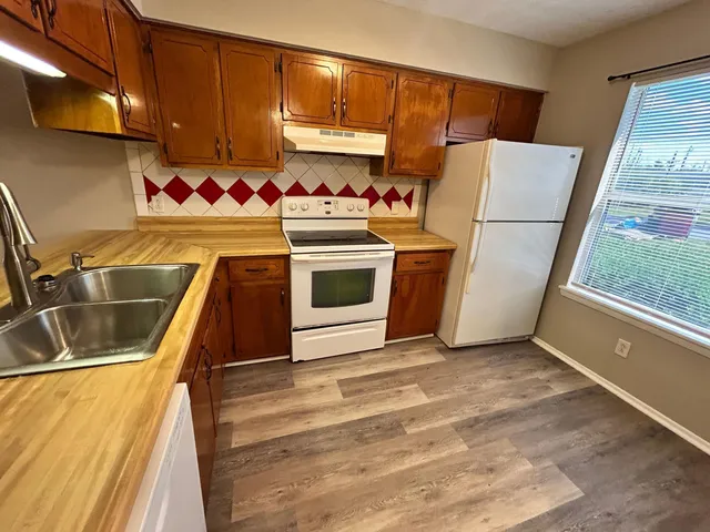 a bathroom with a sink a toilet a mirror and vanity