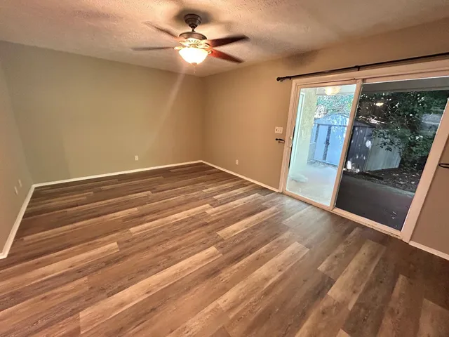wooden floor in an empty room with a fireplace