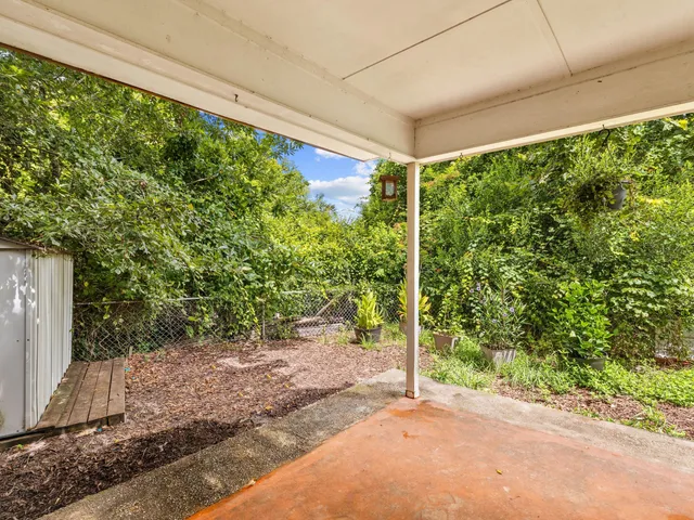 a view of a hallway with wooden floor and closet
