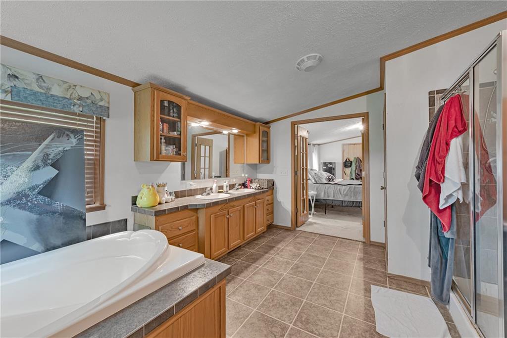 3942 Utah Court Export, PA 15632 - Photo 14 of 24 a large bathroom with a tub sink and mirror