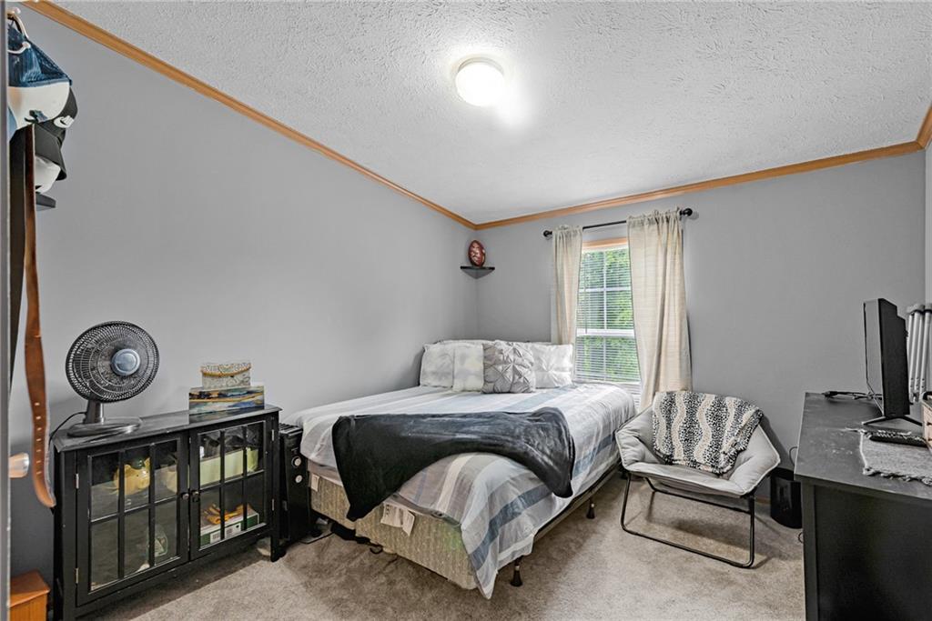 3942 Utah Court Export, PA 15632 - Photo 15 of 24 a bedroom with a bed a mirror and a window
