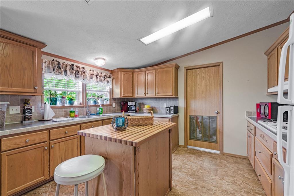 3942 Utah Court Export, PA 15632 - Photo 3 of 24 a kitchen with a sink stove and cabinets
