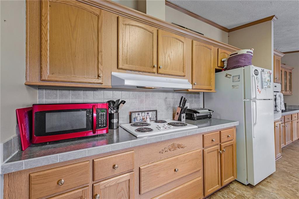 3942 Utah Court Export, PA 15632 - Photo 4 of 24 a kitchen with stainless steel appliances granite countertop a refrigerator and cabinets
