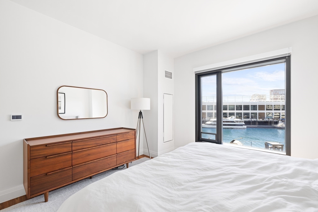 300 Pier 4 Blvd., Unit 3K Boston, MA 02210 - Photo 13 of 24 a bedroom with a bed and a large window