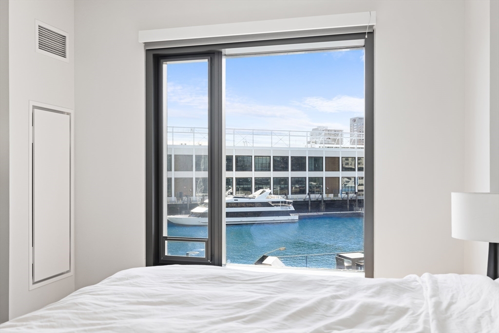 300 Pier 4 Blvd., Unit 3K Boston, MA 02210 - Photo 14 of 24 a view of a bedroom with a bed and a window