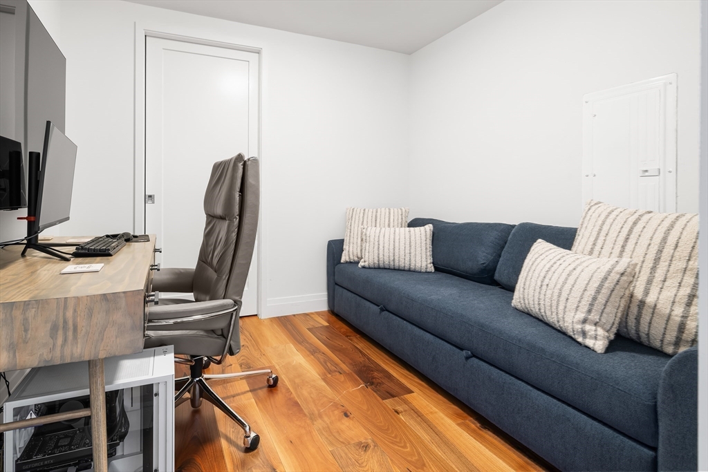 300 Pier 4 Blvd., Unit 3K Boston, MA 02210 - Photo 16 of 24 a living room with furniture and a flat screen tv