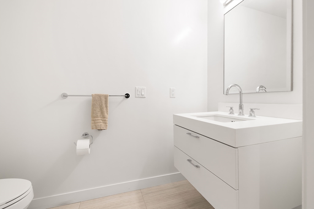300 Pier 4 Blvd., Unit 3K Boston, MA 02210 - Photo 18 of 24 a bathroom with a sink toilet and vanity