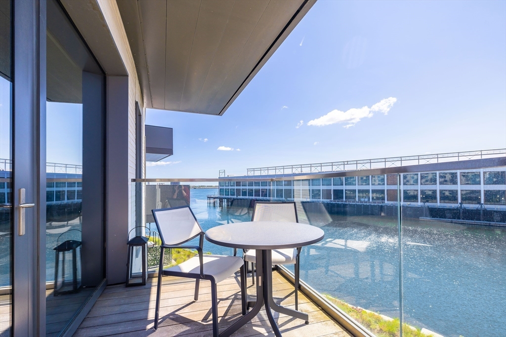300 Pier 4 Blvd., Unit 3K Boston, MA 02210 - Photo 9 of 24 a view of a balcony with a table and chairs