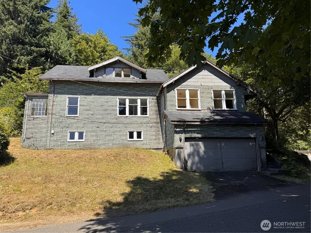 a front view of a house with a yard and garage
