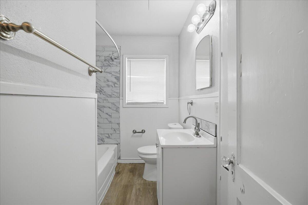 2503 30th Street Lubbock, TX 79410 - Photo 19 of 26 a bathroom with a sink a toilet and shower