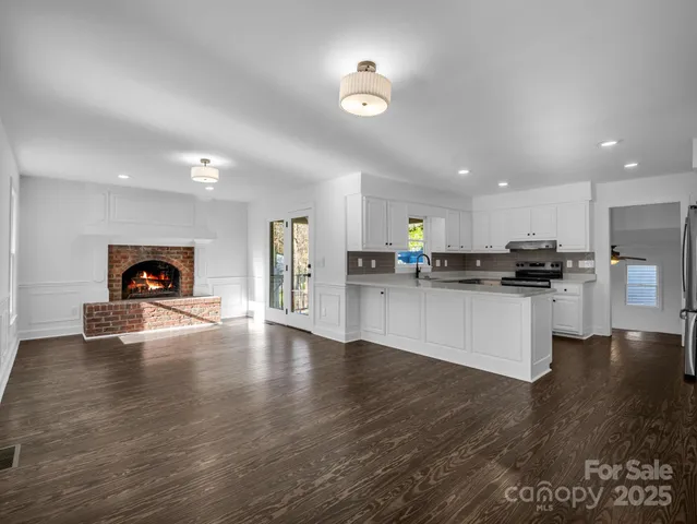 a kitchen with stainless steel appliances a refrigerator and a stove top oven