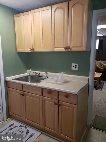 a sink with white cabinets