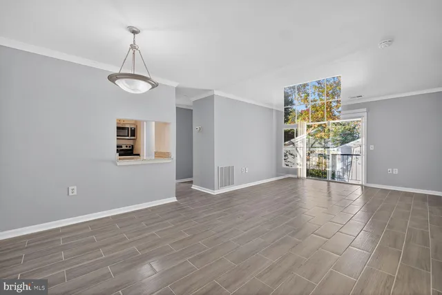 wooden floor in an empty room with a window
