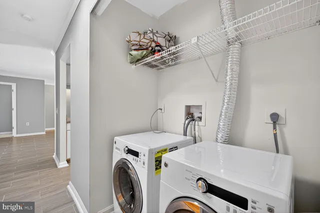 a view of a storage & utility room with a washer dryer
