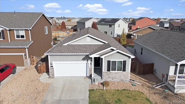 an aerial view of residential houses with yard