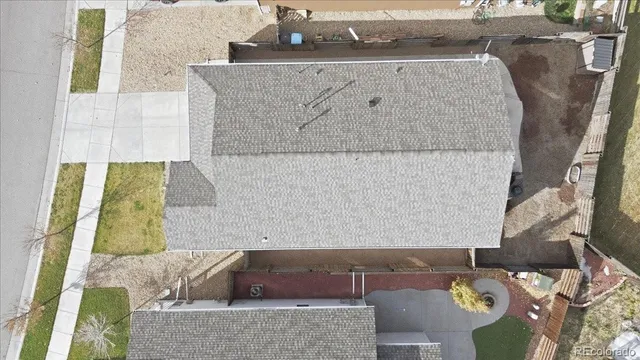 an aerial view of ocean and residential houses with outdoor space