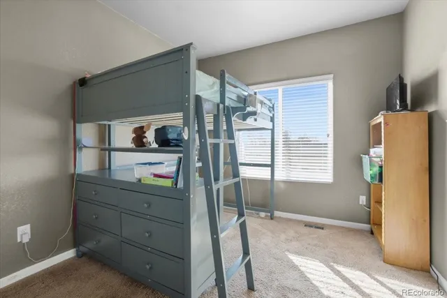 a bathroom with a granite countertop toilet sink and mirror