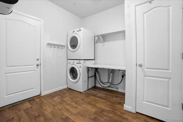 a bedroom with a bed a chandelier and a flat tv screen on dresser
