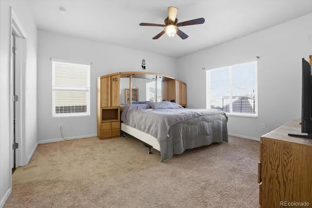 a spacious bedroom with a bed and a chandelier
