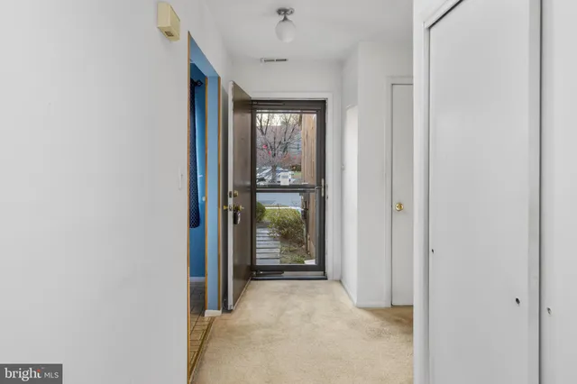 a view of hallway with wooden floor