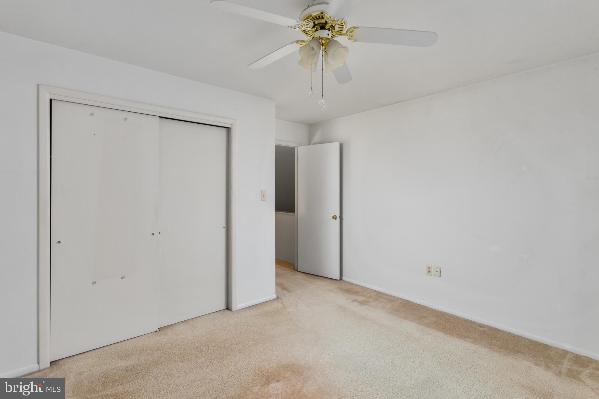 12 Jacob Court Ewing, NJ 08628 - Photo 28 of 45 an empty room with a chandelier fan and closet area