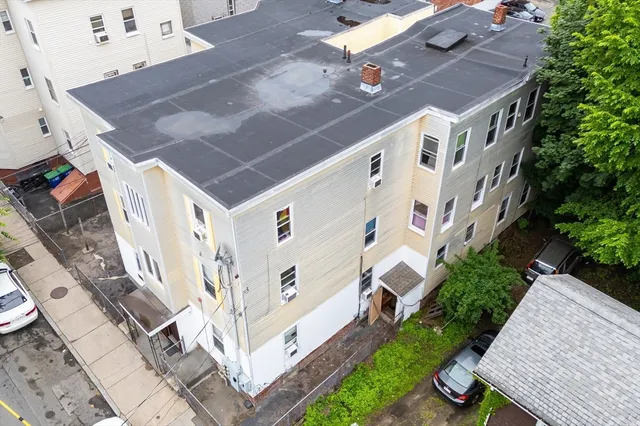 aerial view of a house with a yard