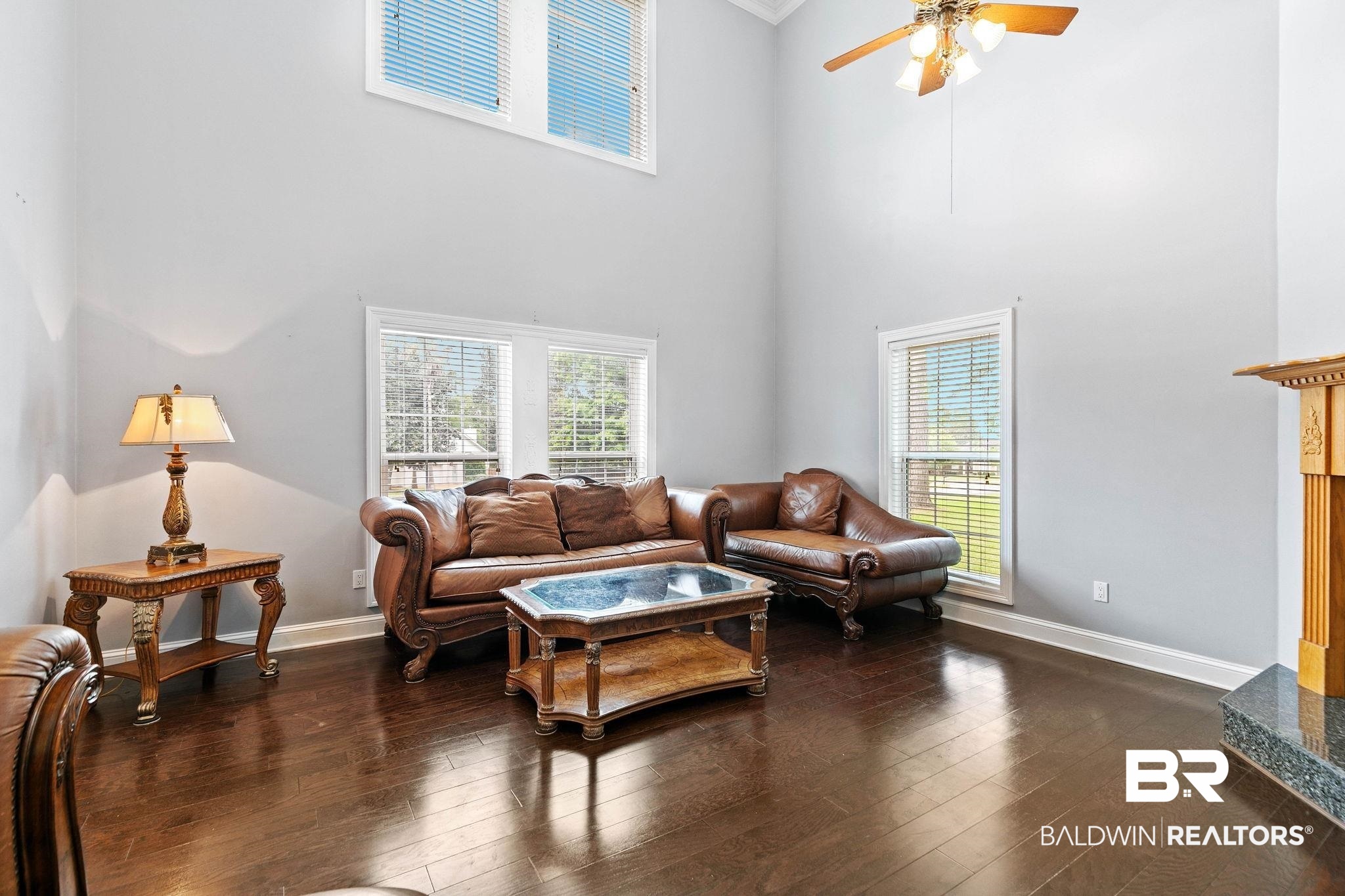 2 Speckle Trout Route Daphne, AL 36527 - Photo 11 of 61 Living room with ceiling fan, dark wood finished floors, plenty of natural light, crown molding, and a high ceiling