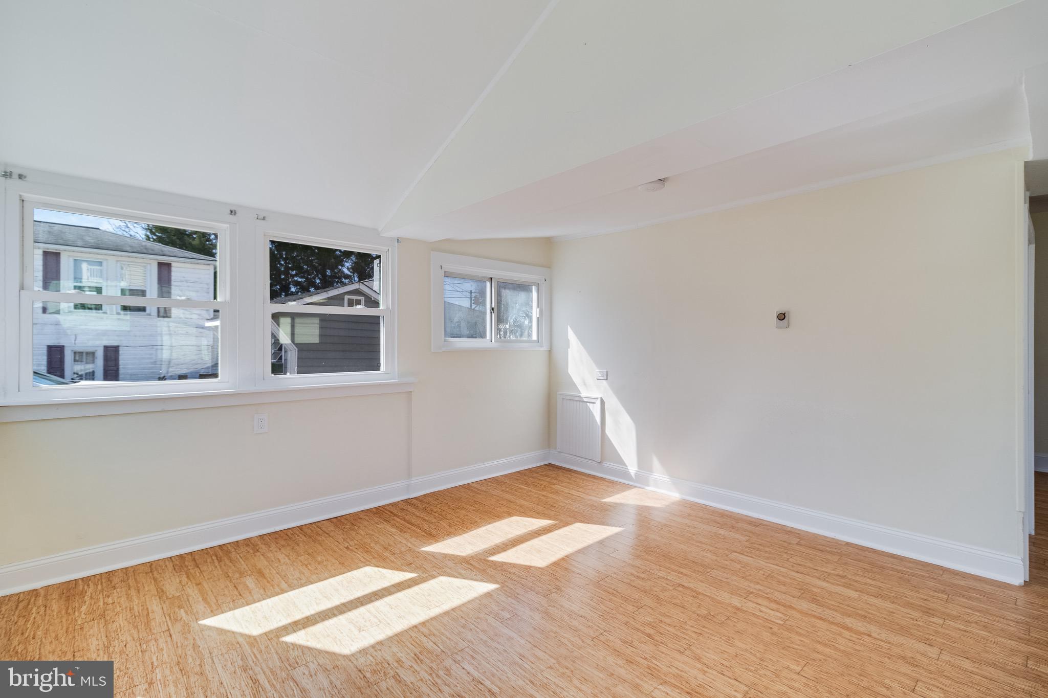 8227 Bayside Road Chesapeake Beach, MD 20732 - Photo 12 of 27 a view of empty room with wooden floor and fan