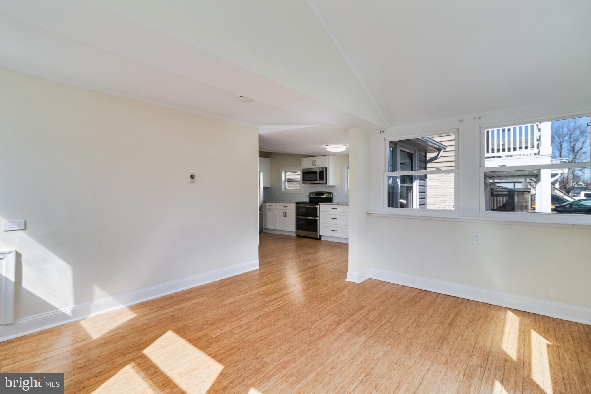 8227 Bayside Road Chesapeake Beach, MD 20732 - Photo 13 of 27 a view of empty room with wooden floor and a window