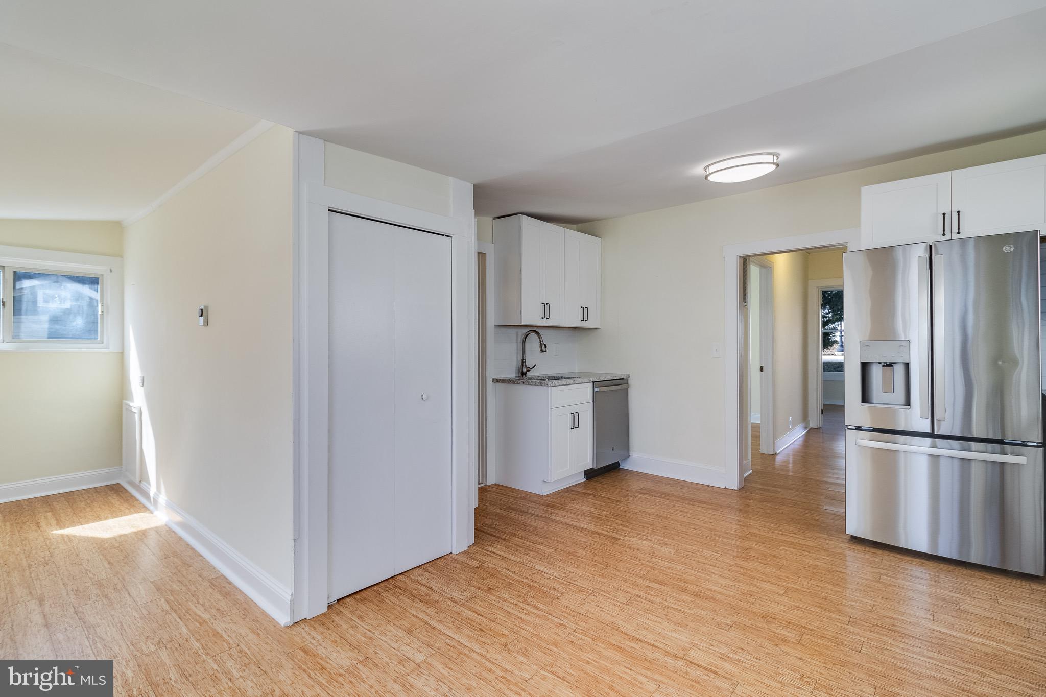 8227 Bayside Road Chesapeake Beach, MD 20732 - Photo 14 of 27 a kitchen with stainless steel appliances wooden floor and large window
