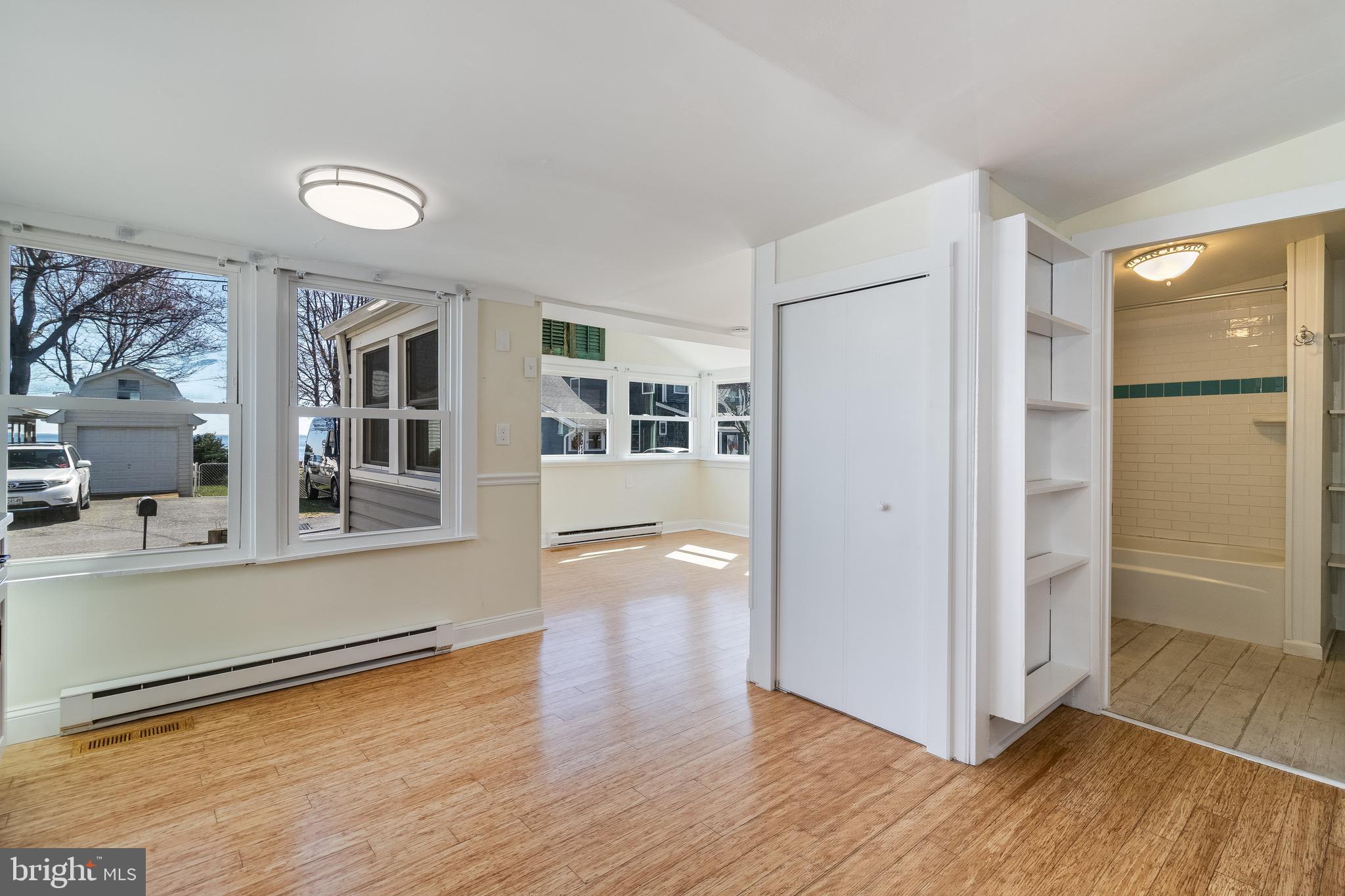 8227 Bayside Road Chesapeake Beach, MD 20732 - Photo 17 of 27 a view of a big room with wooden floor and windows