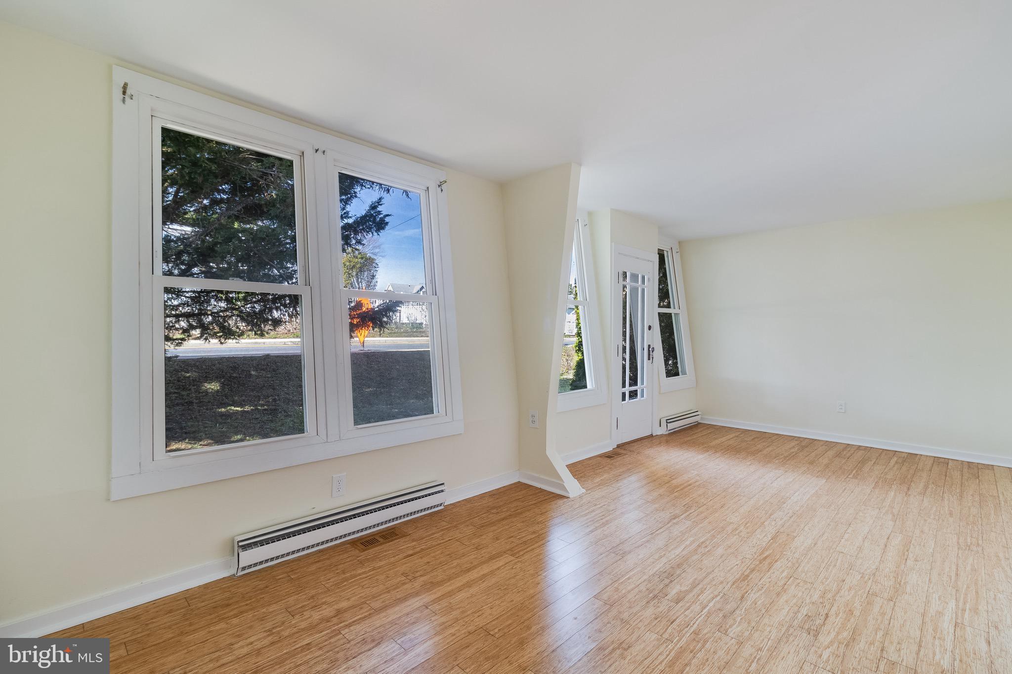 8227 Bayside Road Chesapeake Beach, MD 20732 - Photo 21 of 27 a view of an empty room with wooden floor and a window