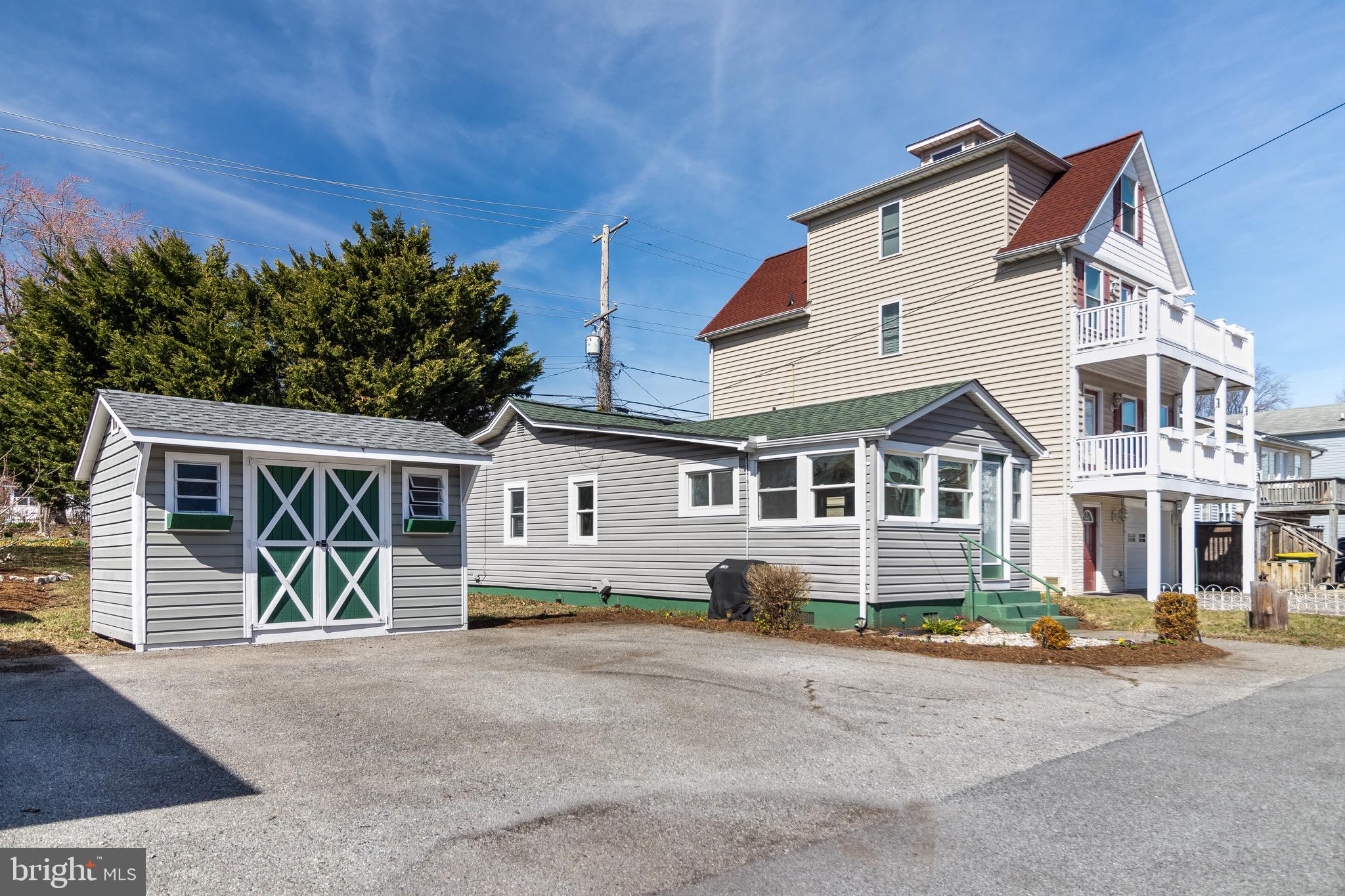 8227 Bayside Road Chesapeake Beach, MD 20732 - Photo 3 of 27 front view of a house with a street