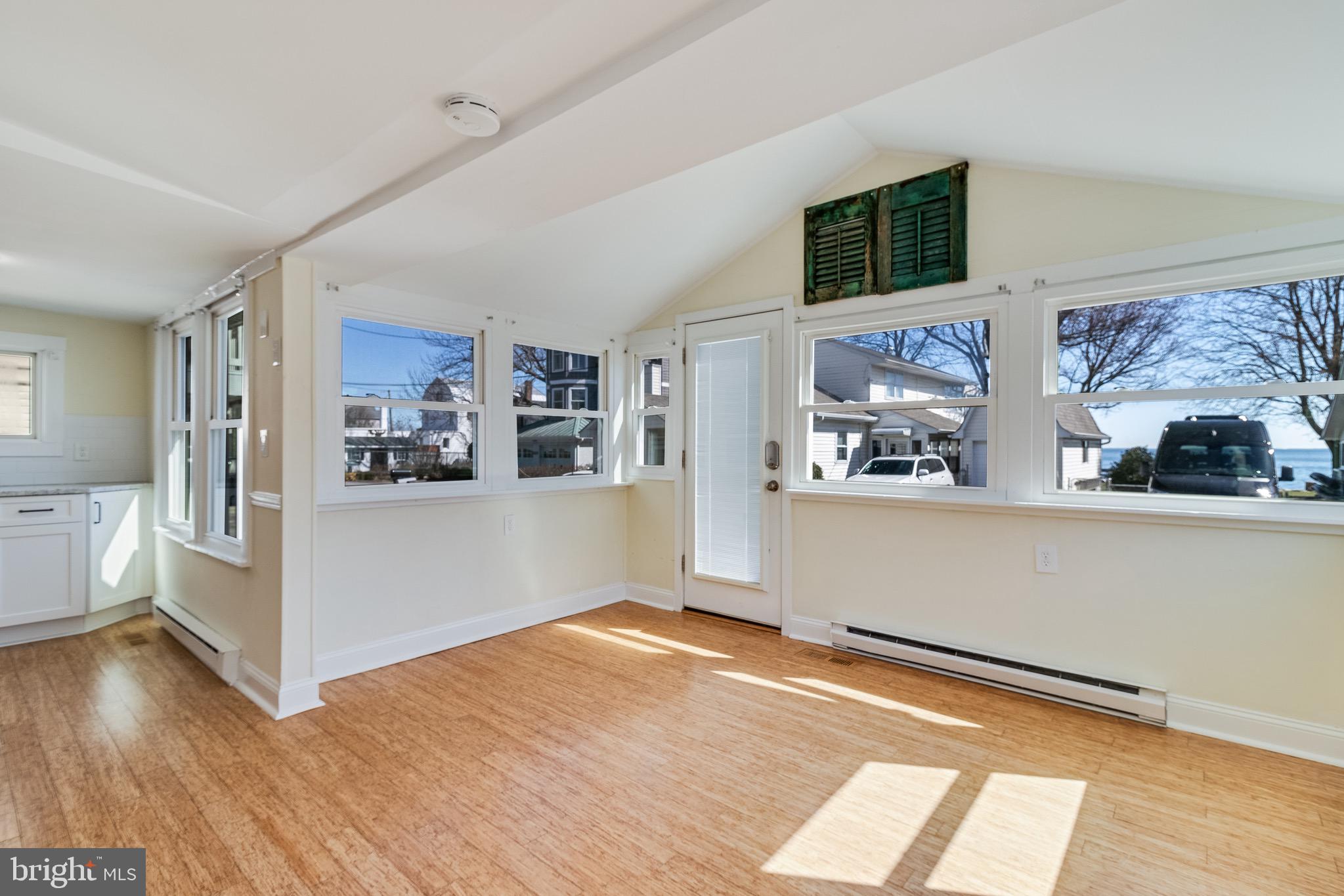 8227 Bayside Road Chesapeake Beach, MD 20732 - Photo 7 of 27 a view of a kitchen with wooden floor and a kitchen