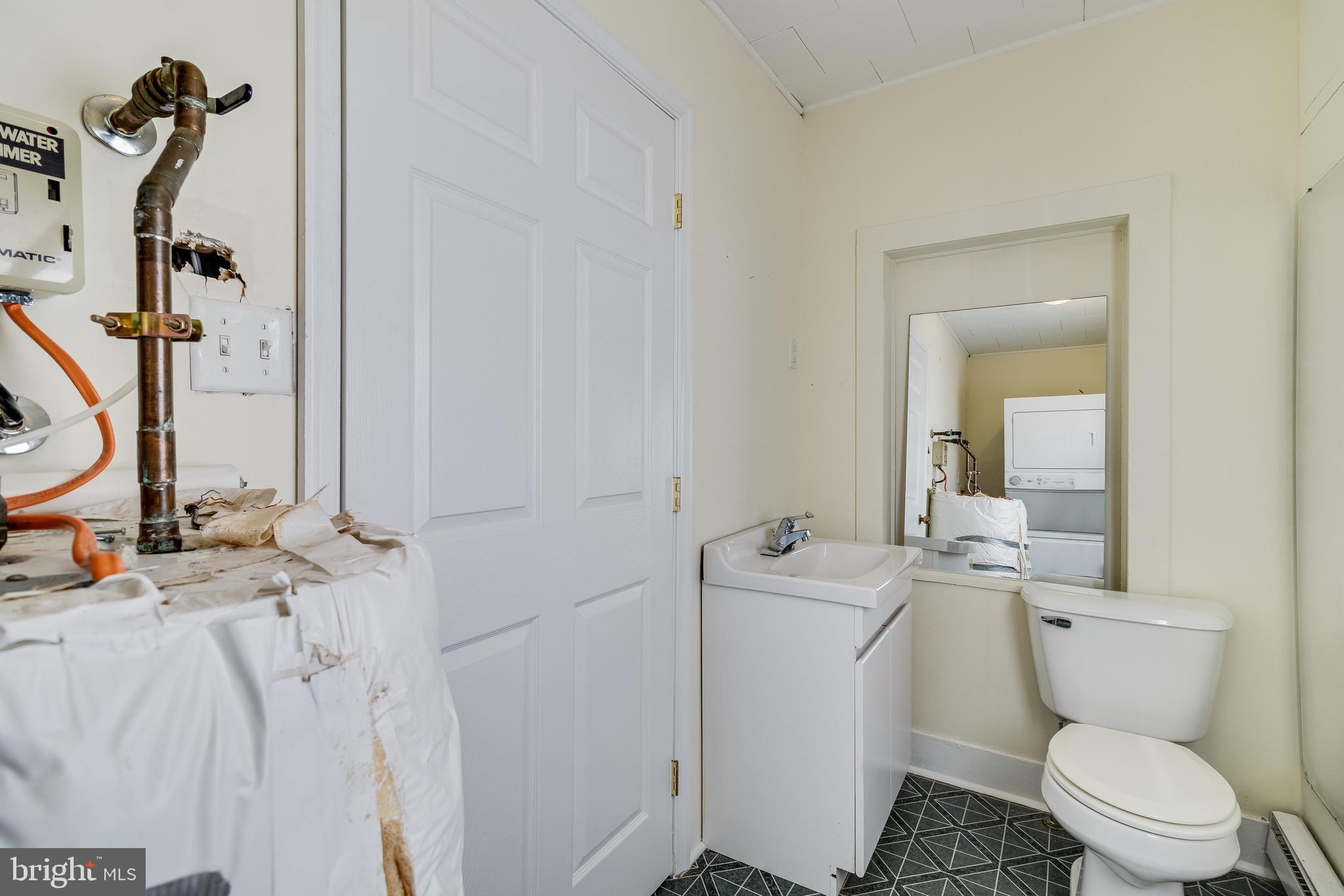 8227 Bayside Road Chesapeake Beach, MD 20732 - Photo 8 of 27 a bathroom with a sink a toilet and mirror