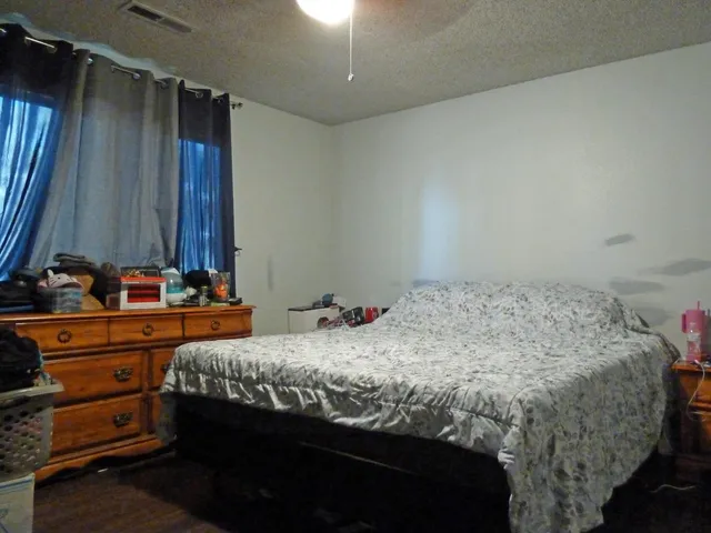 a bedroom with a bed and a dresser