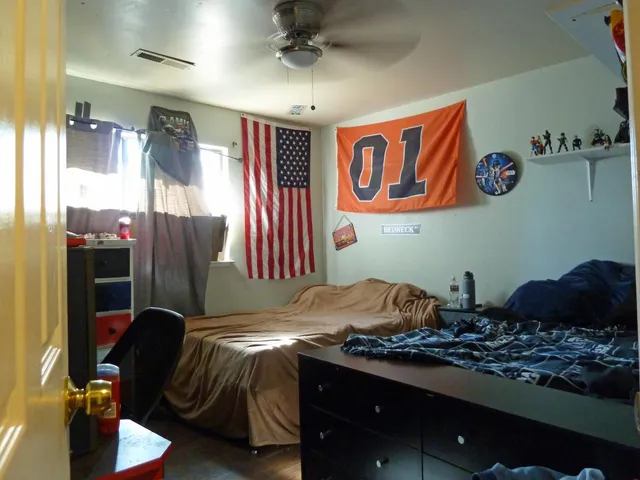 a bedroom with bed and balcony