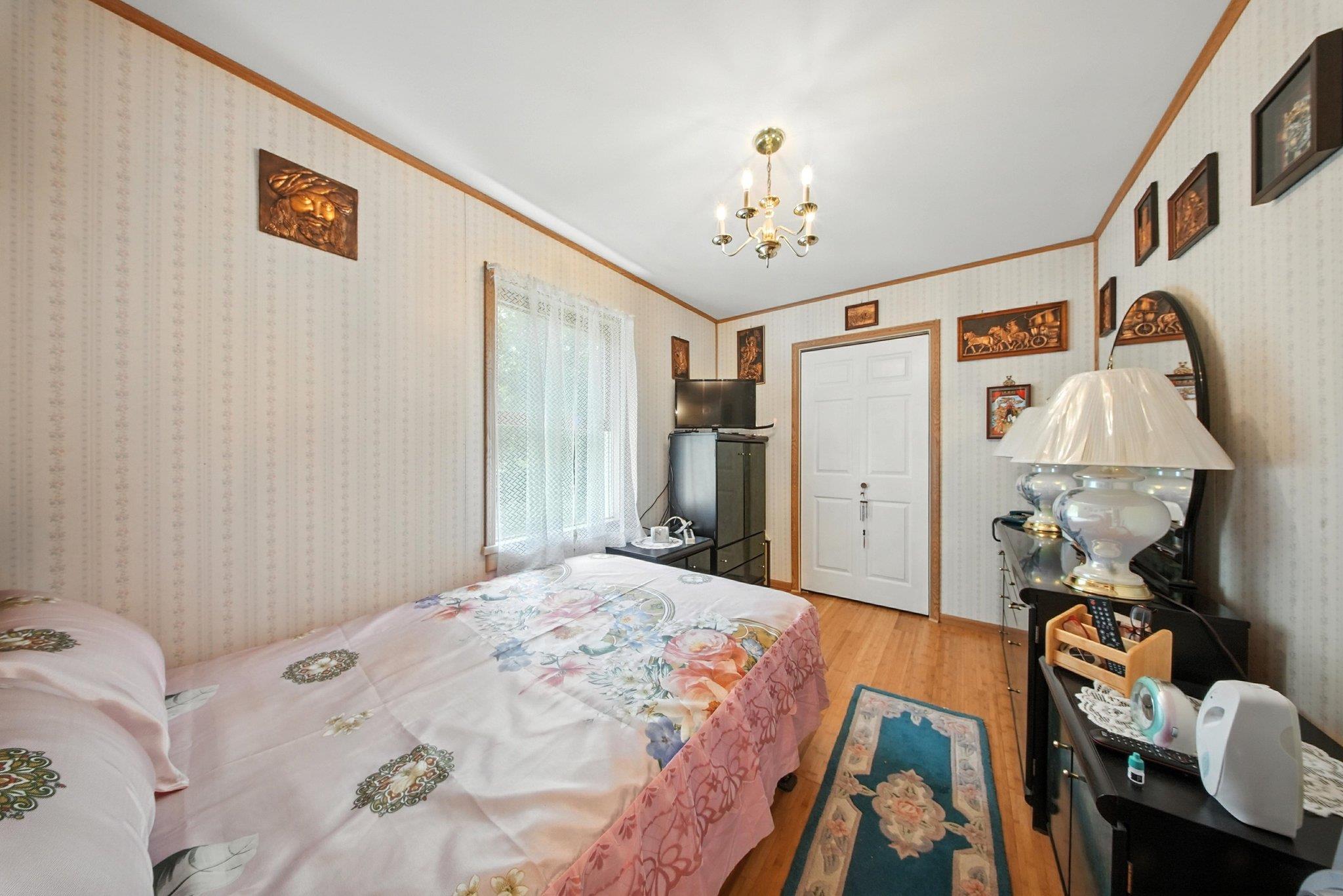 10 Hoffman Road Hankins, NY 12741 - Photo 18 of 30 a bedroom with a bed and a chandelier