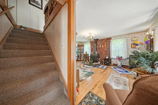 a view of a livingroom with furniture and staircase