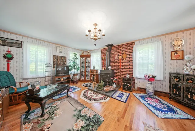 a living room with fireplace furniture and a flat screen tv