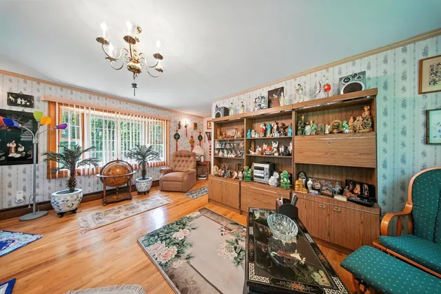 a living room with furniture a couch and bookshelf