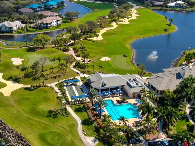 an aerial view of a house with a garden and lake view