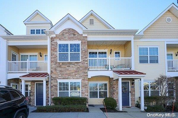 a front view of a residential apartment building with a yard