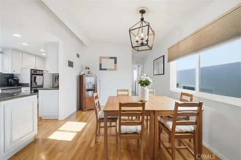 a view of a dining room with furniture wooden floor and a chandelier