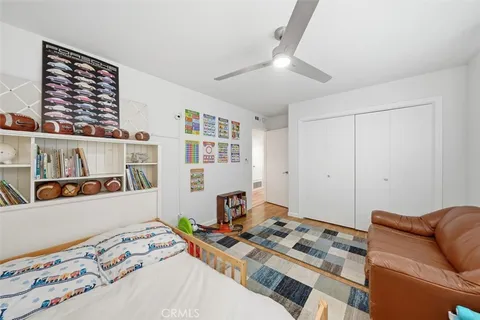 a bedroom with furniture and a book shelf
