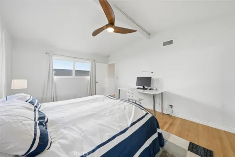 a bedroom with a bed and a chair