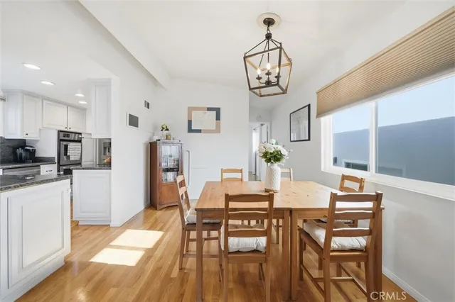 a view of a dining room with furniture wooden floor and a chandelier
